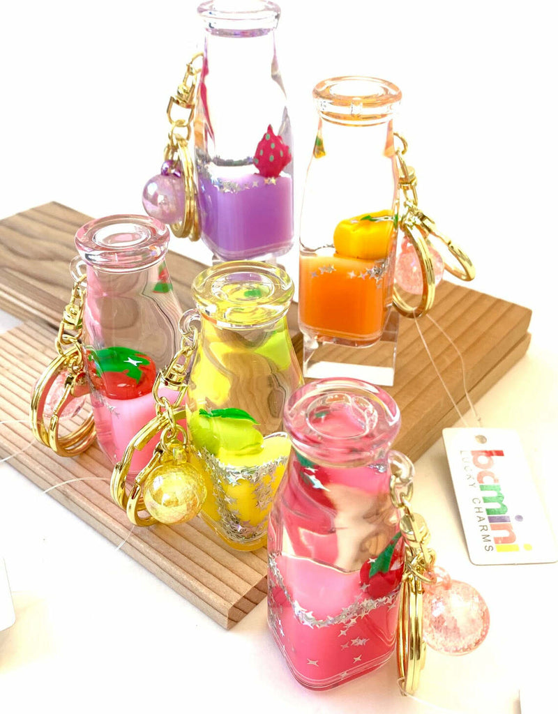 Colorful fruit bottle shaped floating key charm with keyring and clip attachment