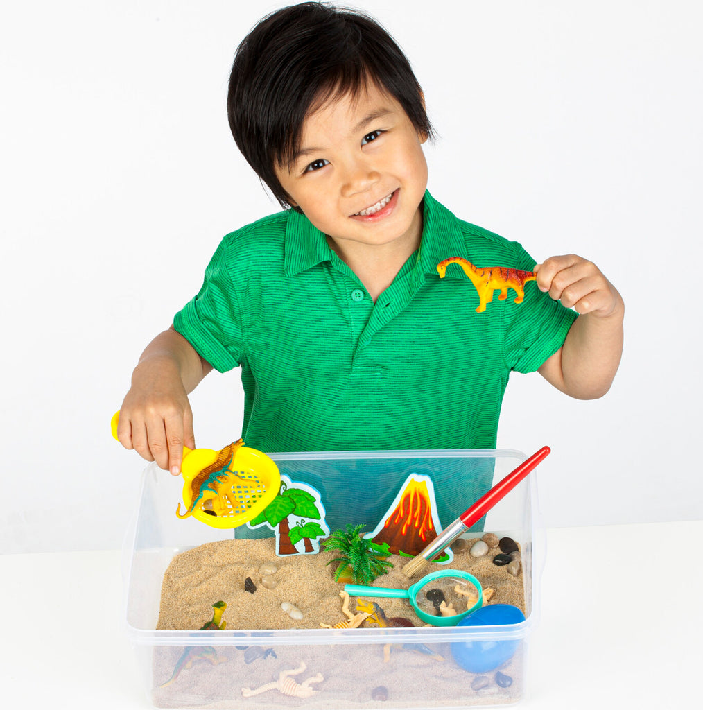 Creativity for Kids Sensory Bin Dinosaur Dig with kinetic sand, dinosaur fossils, and excavation tools