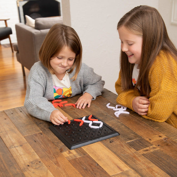 Tic Tac Flip strategy board game with game board and red and white pieces for advanced tic-tac-toe gameplay
