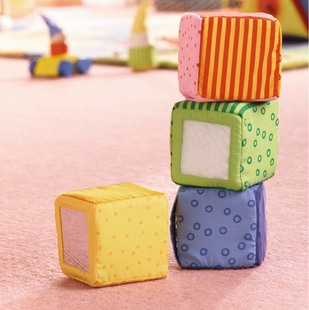 HABA Happy Quartett soft fabric baby blocks with colorful patterns and different sounds for stacking play