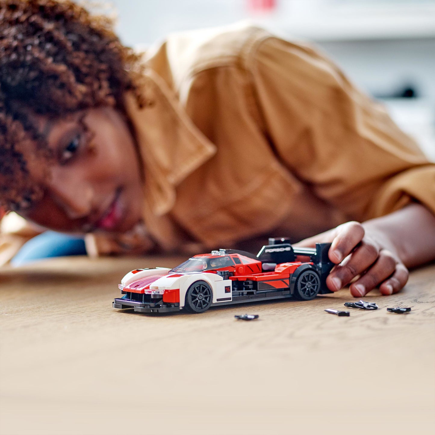 LEGO Speed Champions Porsche 963 model car set with 280 pieces and race driver minifigure