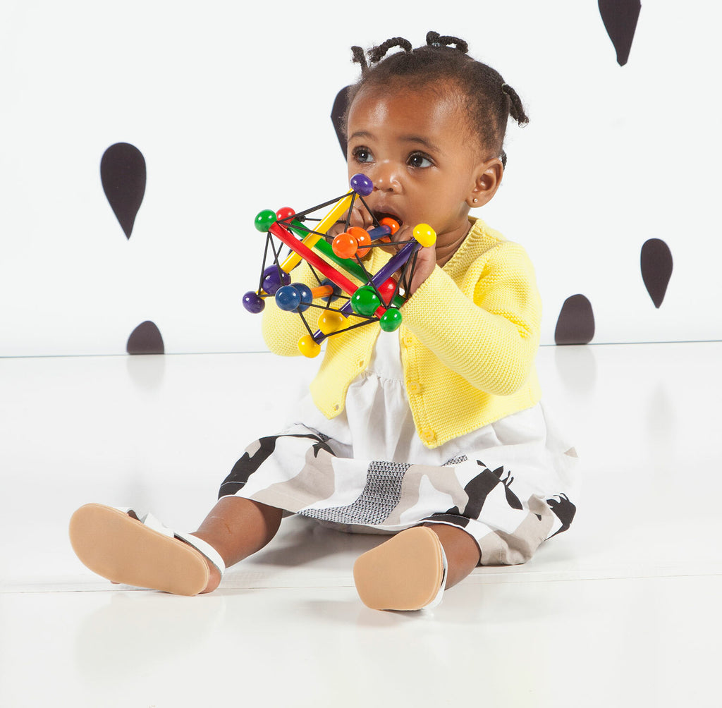 Manhattan Toy Skwish Classic wooden rattle and teether that compresses and returns to original shape with sliding beads