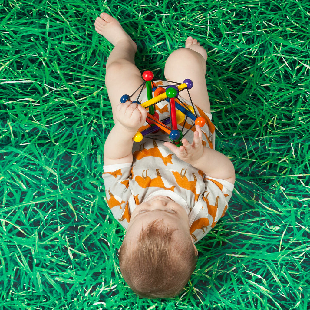 Manhattan Toy Skwish Classic wooden rattle and teether that compresses and returns to original shape with sliding beads