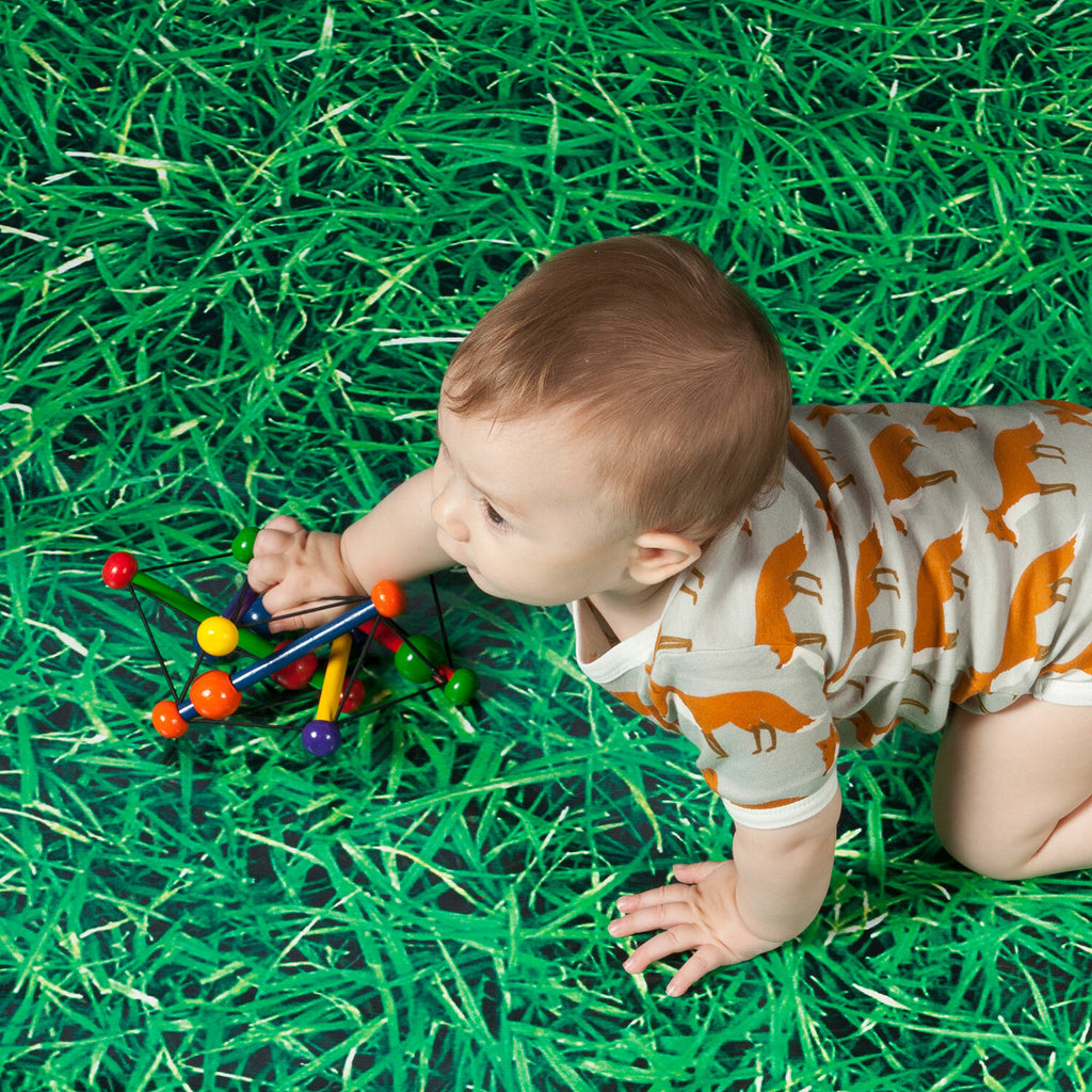 Manhattan Toy Skwish Classic wooden rattle and teether that compresses and returns to original shape with sliding beads