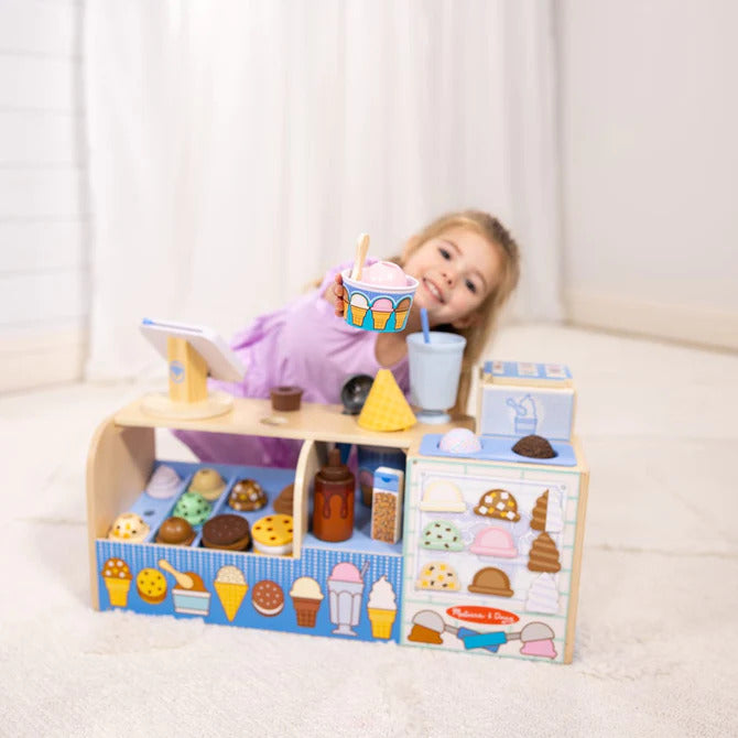 Cool Scoops Ice Creamery pretend play set with wooden counter, ice cream dispenser, scoops, cones, and accessories for children