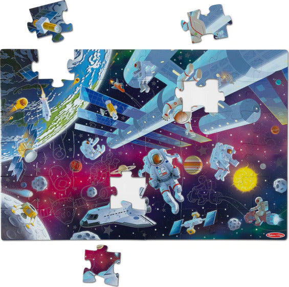Outer Space Glow in the Dark Floor Puzzle showing colorful space scene with planets, astronauts, and spaceships that glows in the dark