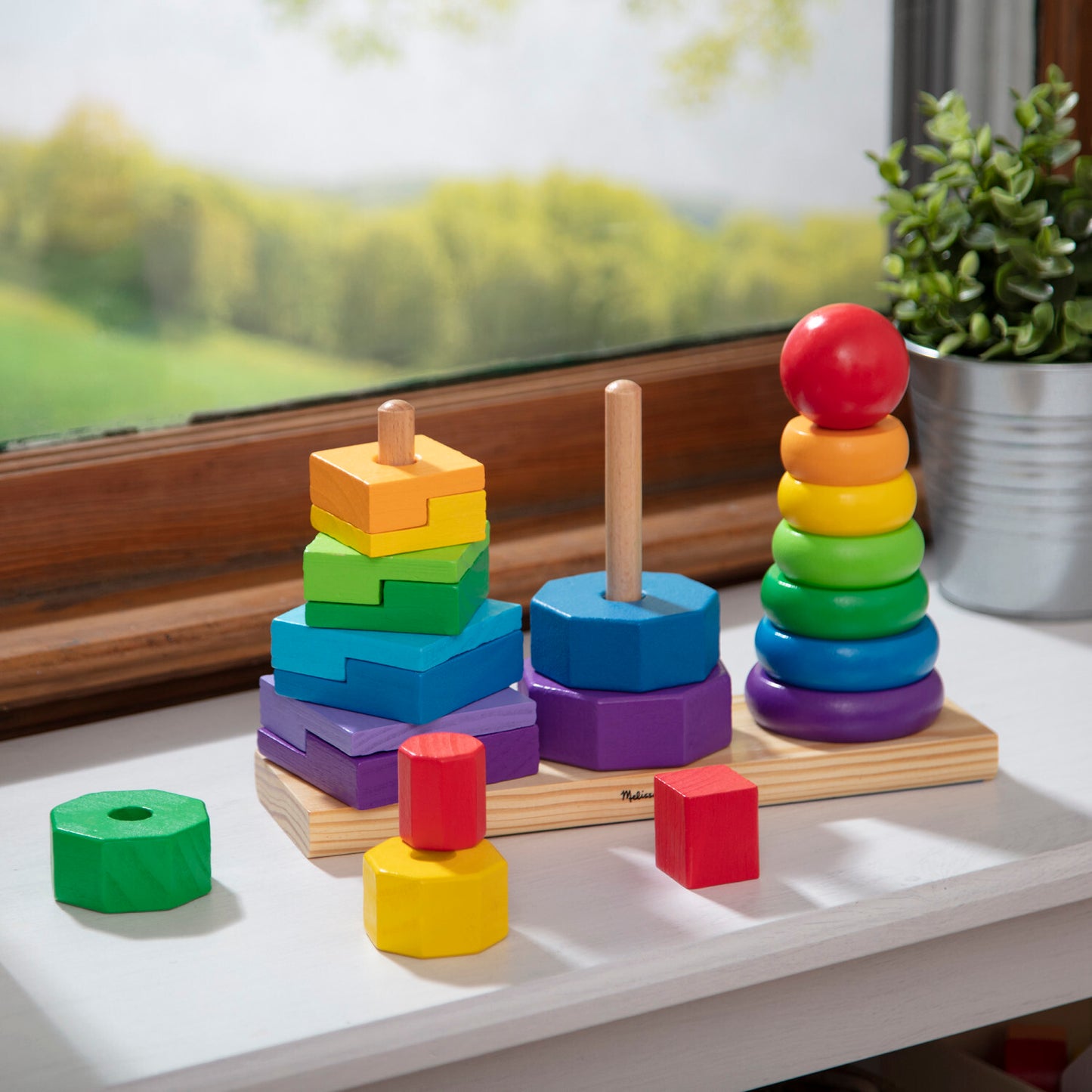Melissa & Doug geometric stacker with colorful wooden shapes on three rods for learning and sorting