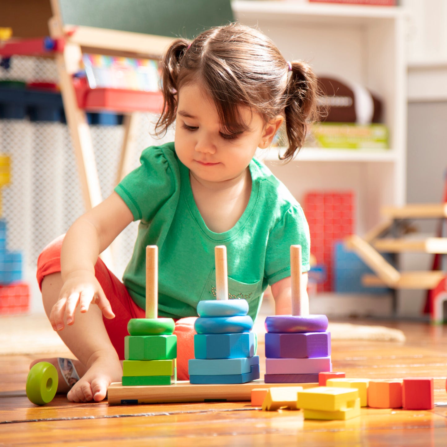 Melissa & Doug geometric stacker with colorful wooden shapes on three rods for learning and sorting
