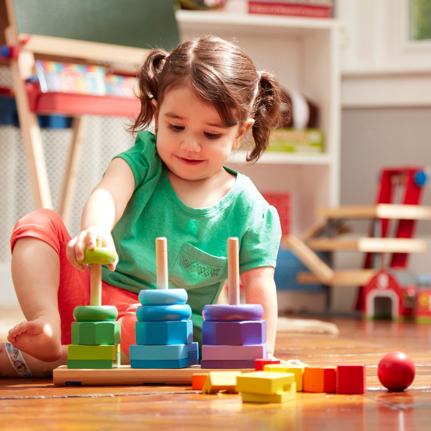 Melissa & Doug geometric stacker with colorful wooden shapes on three rods for learning and sorting