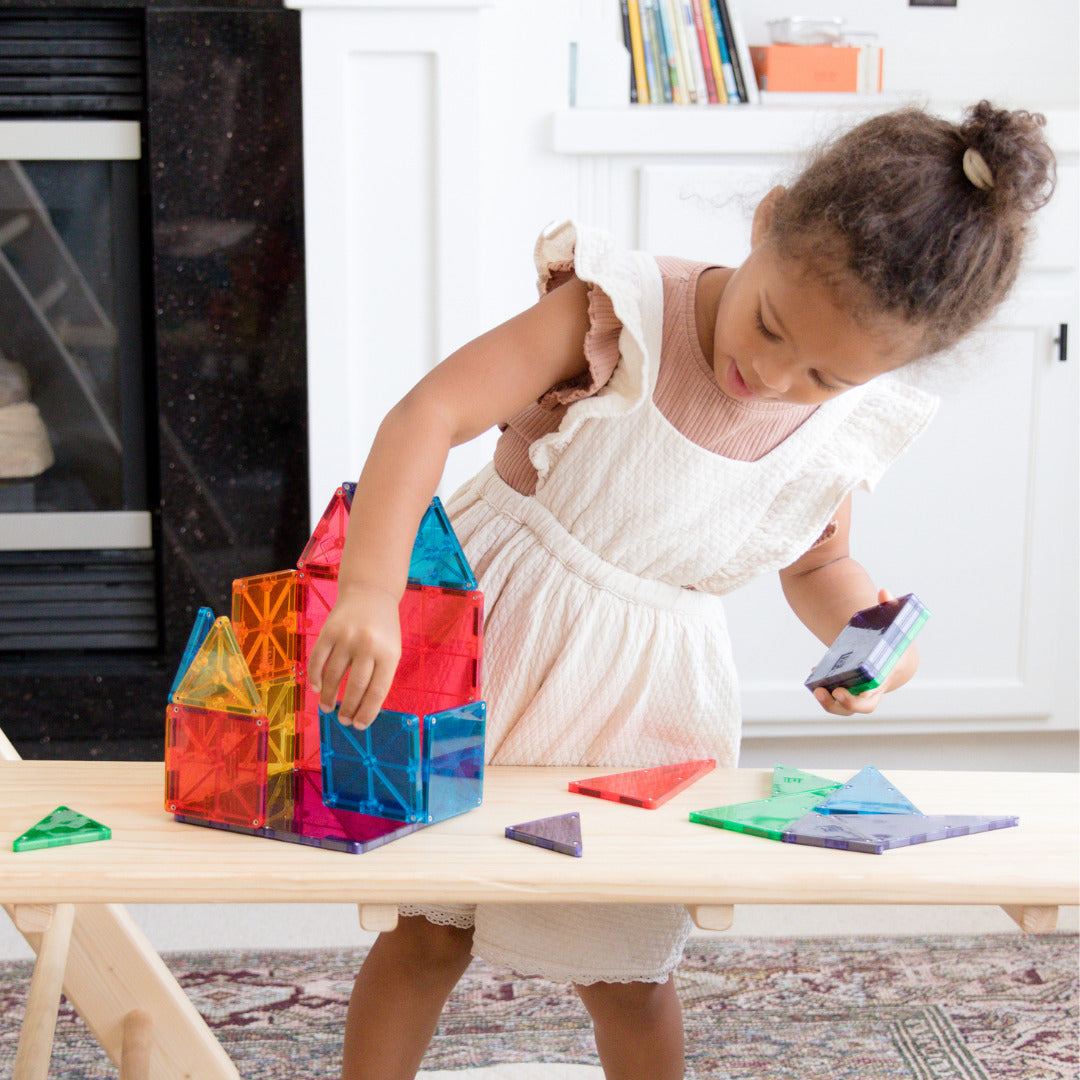 MAGNA-TILES Classic 100-Piece Magnetic Construction Set with colorful geometric shapes including squares and triangles