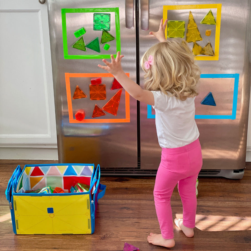 MAGNA-TILES Classic 100-Piece Magnetic Construction Set with colorful geometric shapes including squares and triangles