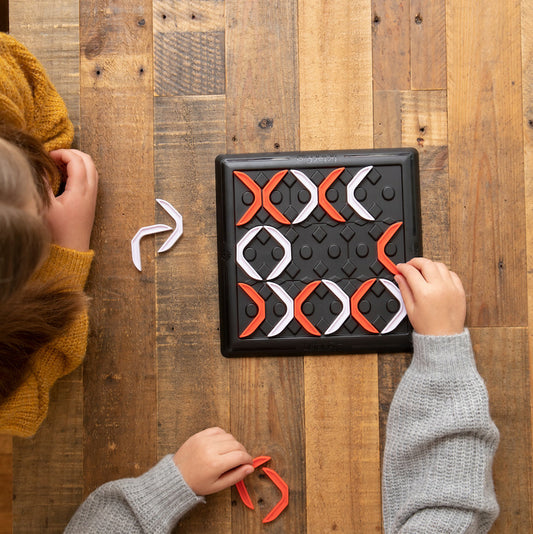 Tic Tac Flip strategy board game with game board and red and white pieces for advanced tic-tac-toe gameplay