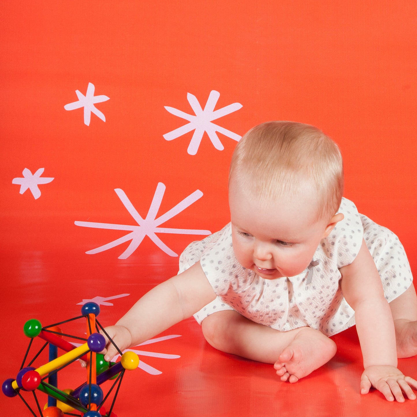 Manhattan Toy Skwish Classic wooden rattle and teether that compresses and returns to original shape with sliding beads