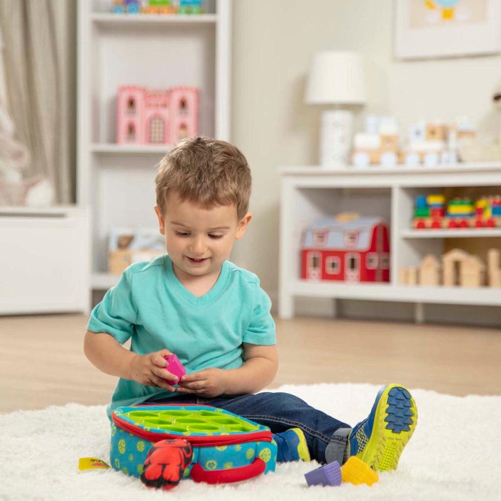 Melissa & Doug take-along shape sorter with colorful shapes and portable carrying handle for babies